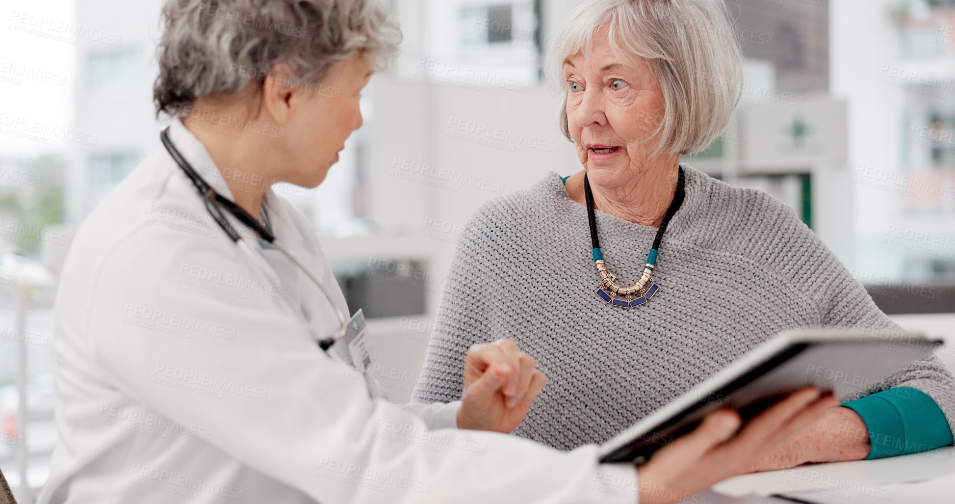 Buy stock photo Senior doctor, tablet and discussion with patient for healthcare prescription or diagnosis at hospital. Mature medical professional talking to elderly female person on technology for consultation