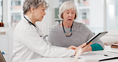 Senior doctor, tablet and consulting patient for healthcare advice, prescription or diagnosis at hospital. Mature medical professional talking to elderly female person on technology for consultation