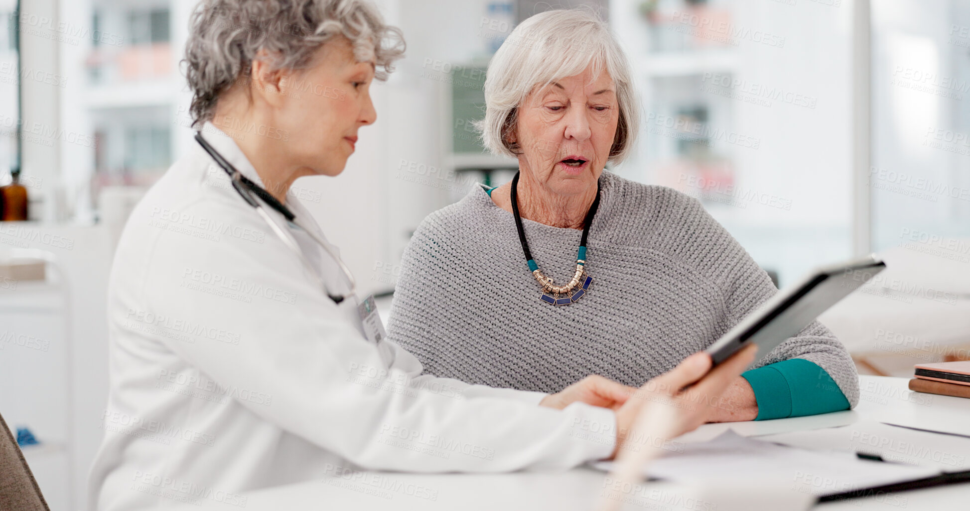 Buy stock photo Senior doctor, tablet and consulting patient for healthcare advice, prescription or diagnosis at hospital. Mature medical professional talking to elderly female person on technology for consultation