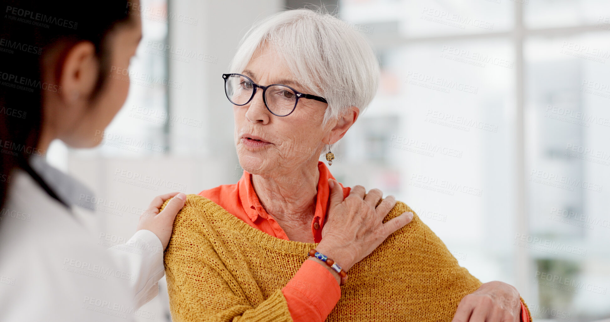 Buy stock photo Medical, shoulder pain and a senior woman with her doctor in the hospital, talking during a consultation. Healthcare, insurance or anatomy and a woman patient in a clinic with a medicine professional