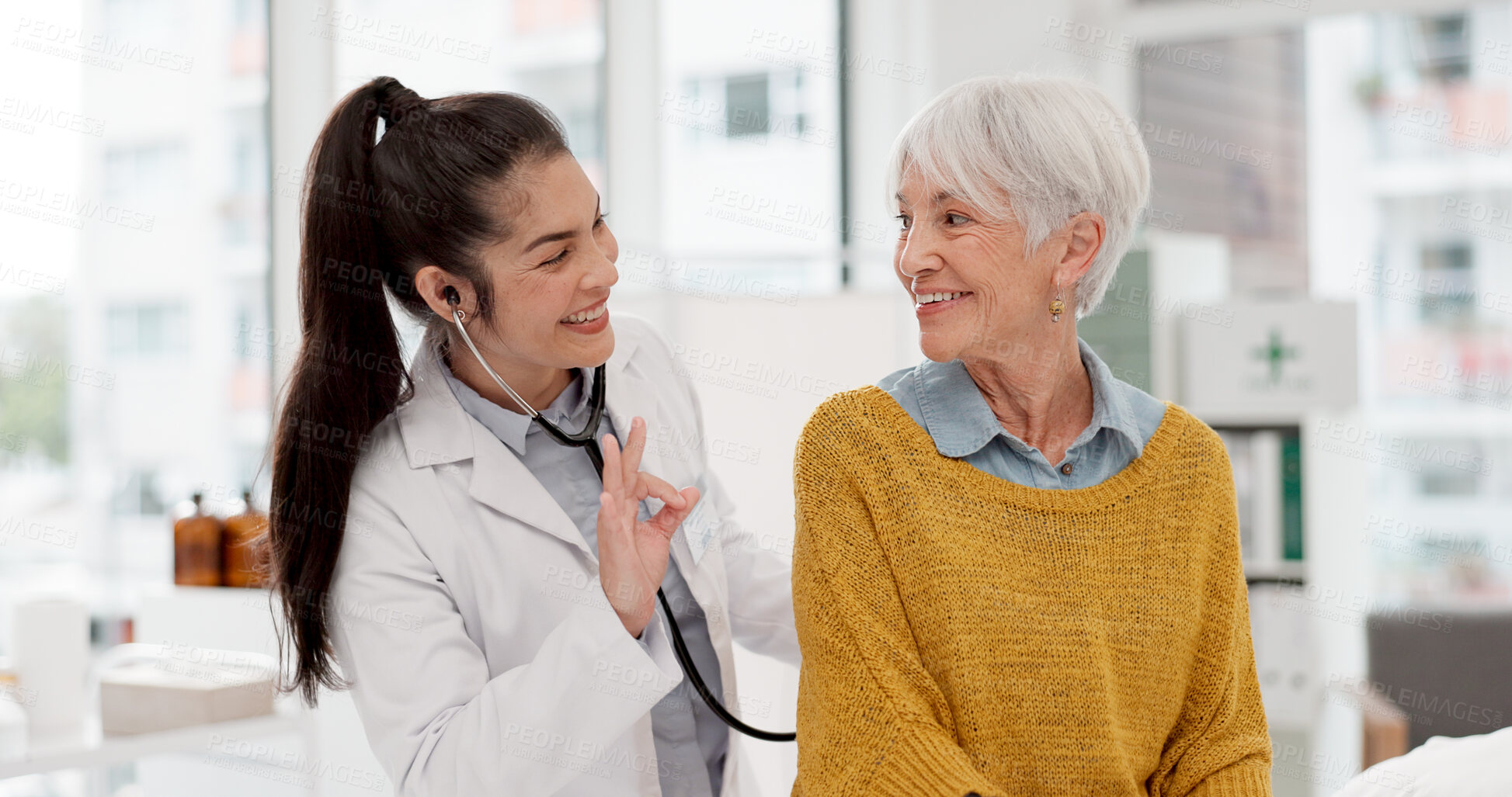 Buy stock photo Healthcare, listening and a doctor with a woman for breathing check during a consultation. Talking, help and a medical employee with a stethoscope and senior patient for a heart test at a clinic