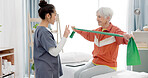 Elderly woman doing exercise with a resistance band for physical therapy with nurse in clinic. Fitness, healthcare and female patient doing arm workout with a physiotherapist in rehabilitation center