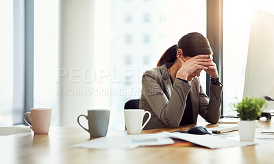 Buy stock photo Cropped shot of a young businesswoman looking stressed out while working in an office