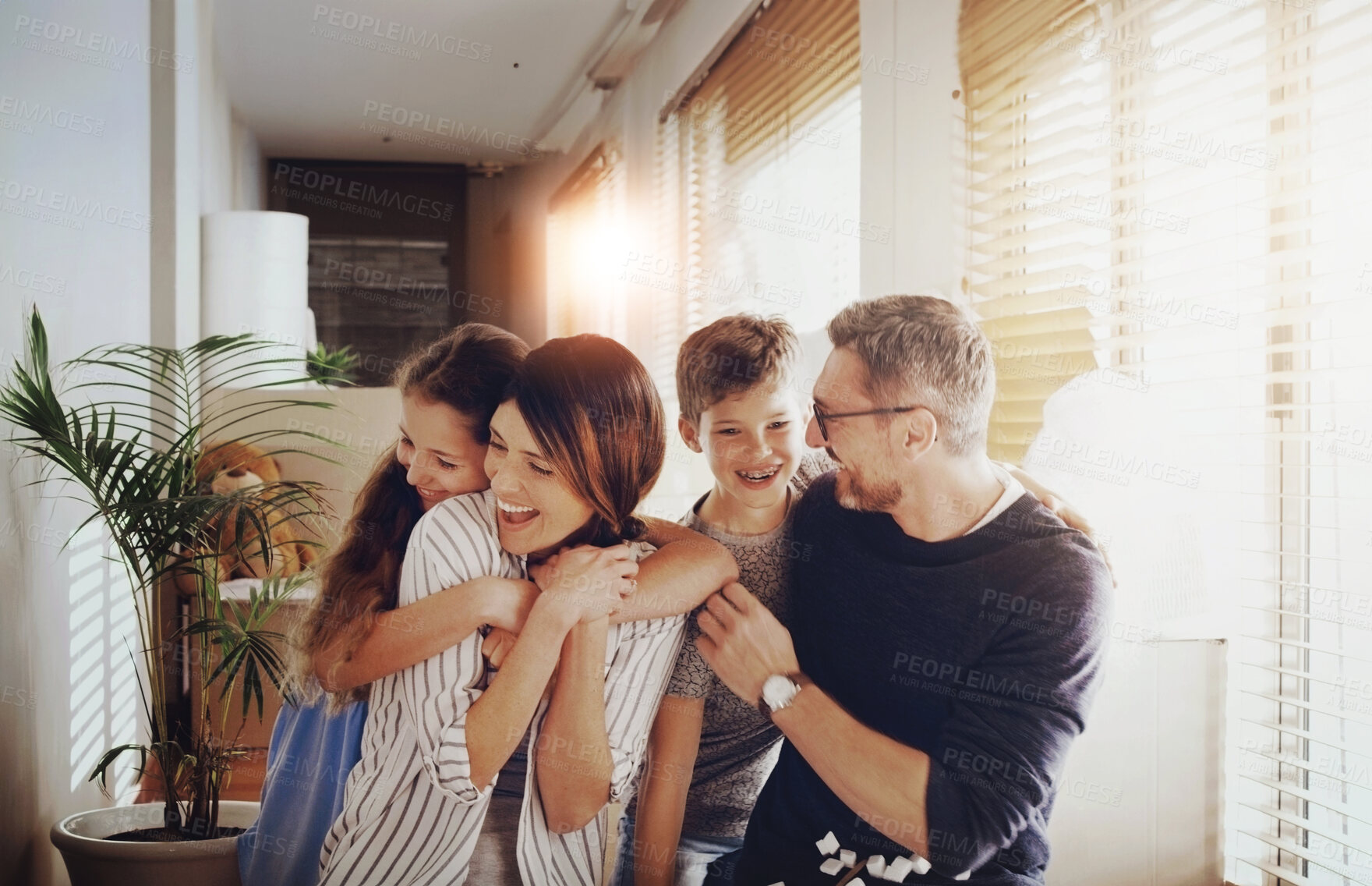 Buy stock photo Happy, home and parents hug children for cuddle, love and healthy relationship for bonding, trust and care. Family, morning and mom, dad and kids embrace for affection in living room together