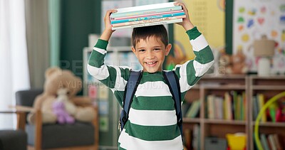 Child, face and book on head with laugh in classroom for learning education for back to school, library or alphabet. Boy, kid and happy laughing for future academic with funny joke, student or story