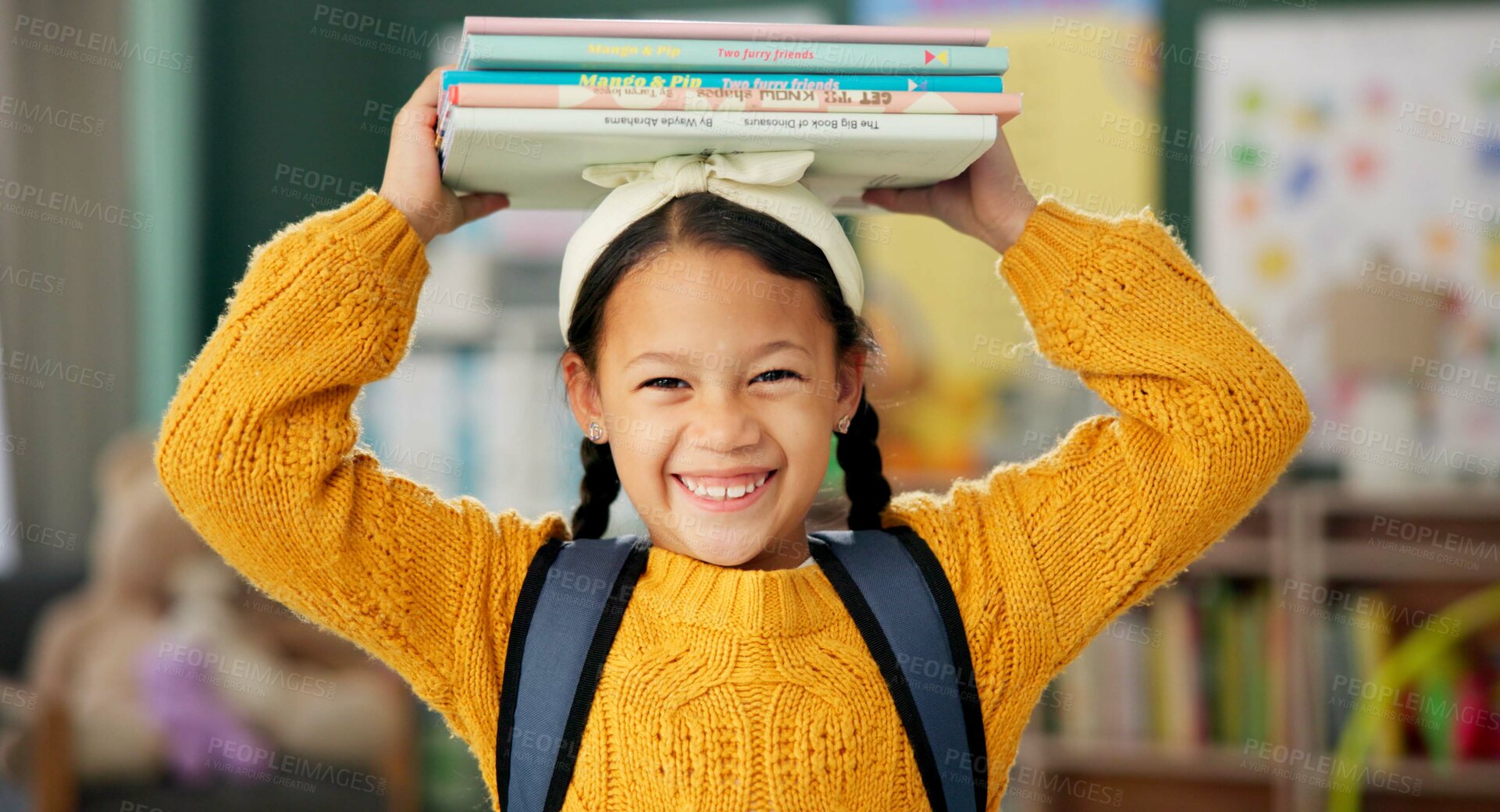 Buy stock photo Child, face and books on head or excited for school learning or reading lesson, classroom or education. Girl, kid and portrait as youth student for academic development or knowledge, study or happy