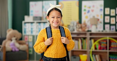 Buy stock photo Child, face and smile in classroom with backpack for back to school excited with education, learning or youth. Girl, kid and happiness for first day as elementary student, scholarship or knowledge