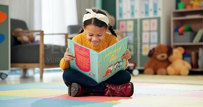 Girl, school and reading book in classroom, childhood development and growth for vocabulary in kindergarten. Happy, smile and knowledge or information with storybook, learning and fantasy for child