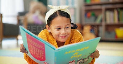 Girl, school and reading book in class, childhood development and growth for vocabulary in kindergarten. Happy, smile and knowledge or information with storybook, learning and fantasy for child