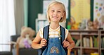 Happy, face and child in classroom for education, learning and ready for morning kindergarten. Smile, school and portrait of girl or student with knowledge, studying and pride for academic lesson