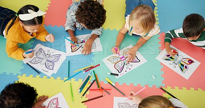 Buy stock photo Children, group and drawing for creative learning in classroom for education, project or back to school. Boys, girls and friends on floor mat for student art lesson or Montessori, youth or playing