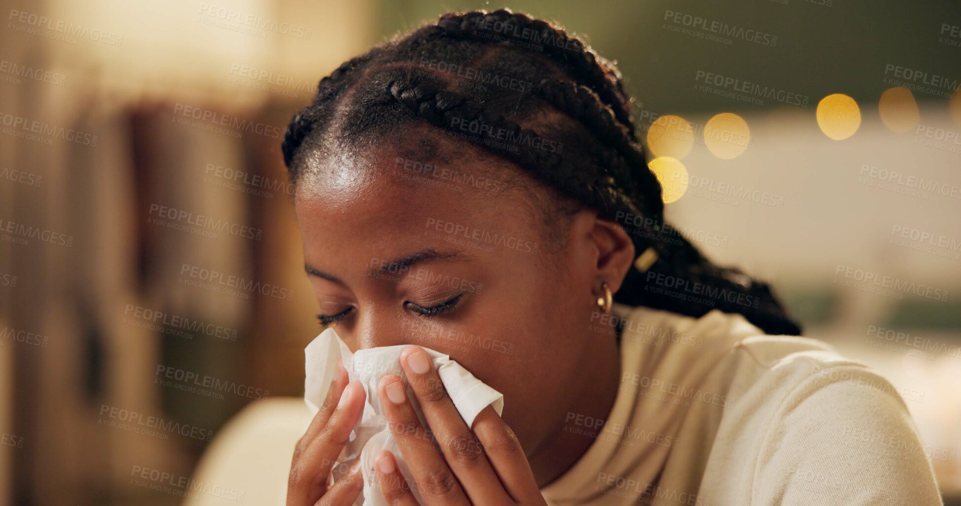 Buy stock photo Woman, sick and tissue for sneezing in home with blowing nose, recovery and night virus in living room. African person, infection or ill with fever, sinus and allergy with healthcare and suffering