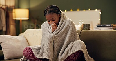 Buy stock photo Woman, sick and tissue with blanket on sofa for blowing nose, recovery and winter virus in living room. African person, infection or ill with fever, sinus and allergy on couch in home with healthcare