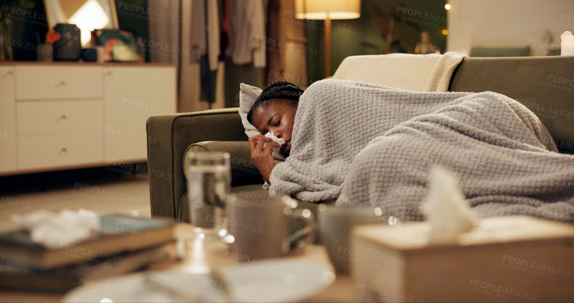 Buy stock photo Woman, sick and sneezing with blanket on sofa for blowing nose, recovery and winter virus in living room. Black person, infection or ill with fever, sinus and allergy on couch in home with healthcare