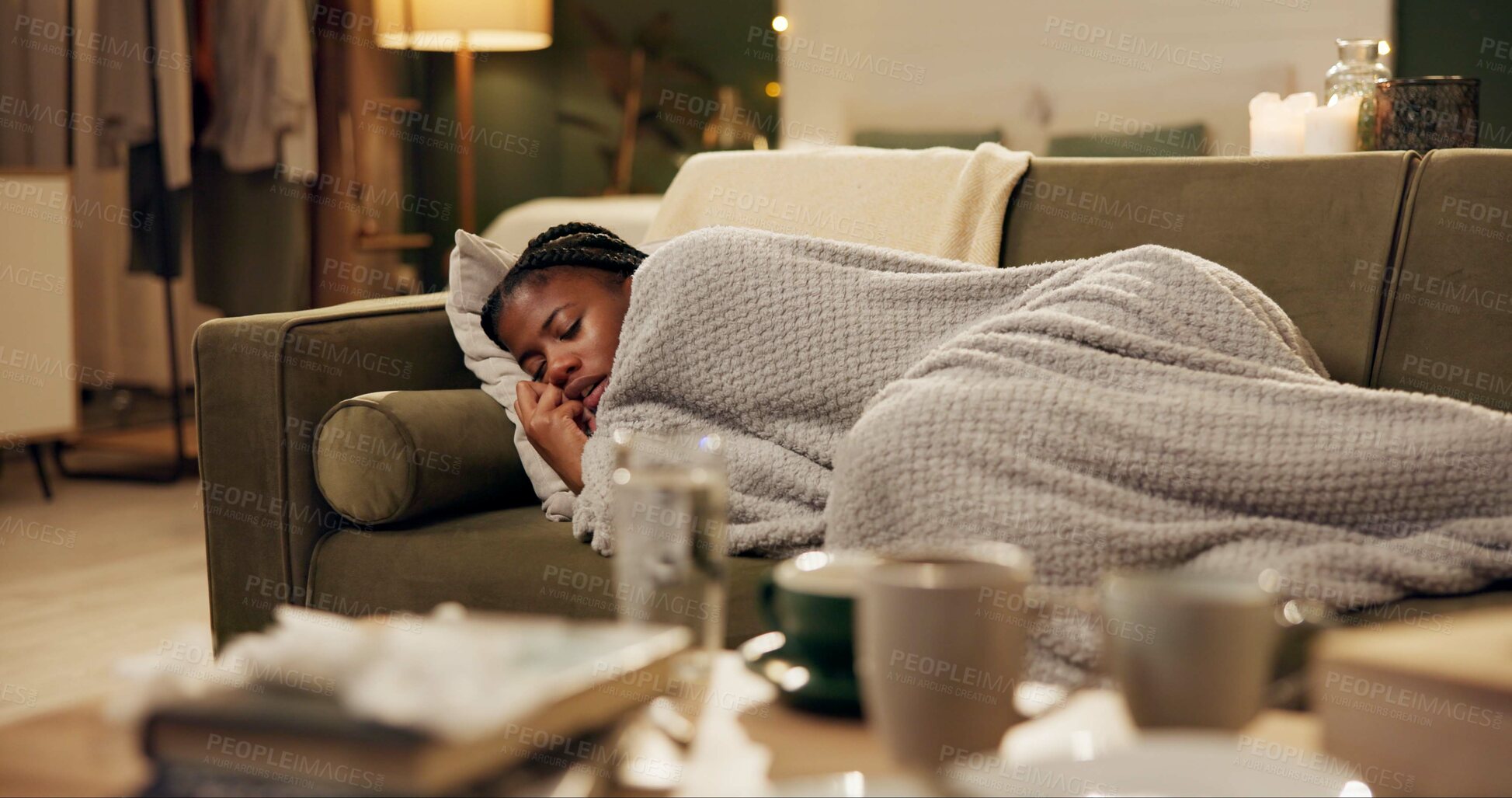 Buy stock photo Woman, sick and sneezing with blanket on sofa for blowing nose, recovery and winter virus in living room. Black person, infection or ill with fever, sinus and allergy on couch in home with healthcare