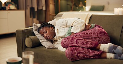 African woman, menstruation and stomach on couch with pain, stress and cramps at night in living room. Girl, person and holding sore abdomen with virus, constipation and ibs on lounge sofa in home