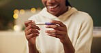 Woman, pregnancy test and excited or surprised in home with good news, fertility and ivf success journey. Hands, new mother and happy with results of testing kit on sofa for future motherhood and wow