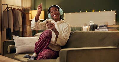 Buy stock photo African woman, headphones and phone on couch with smile, singing or dancing to music in home living room. Girl, smartphone and happy for streaming, audio subscription and mobile app on sofa in house