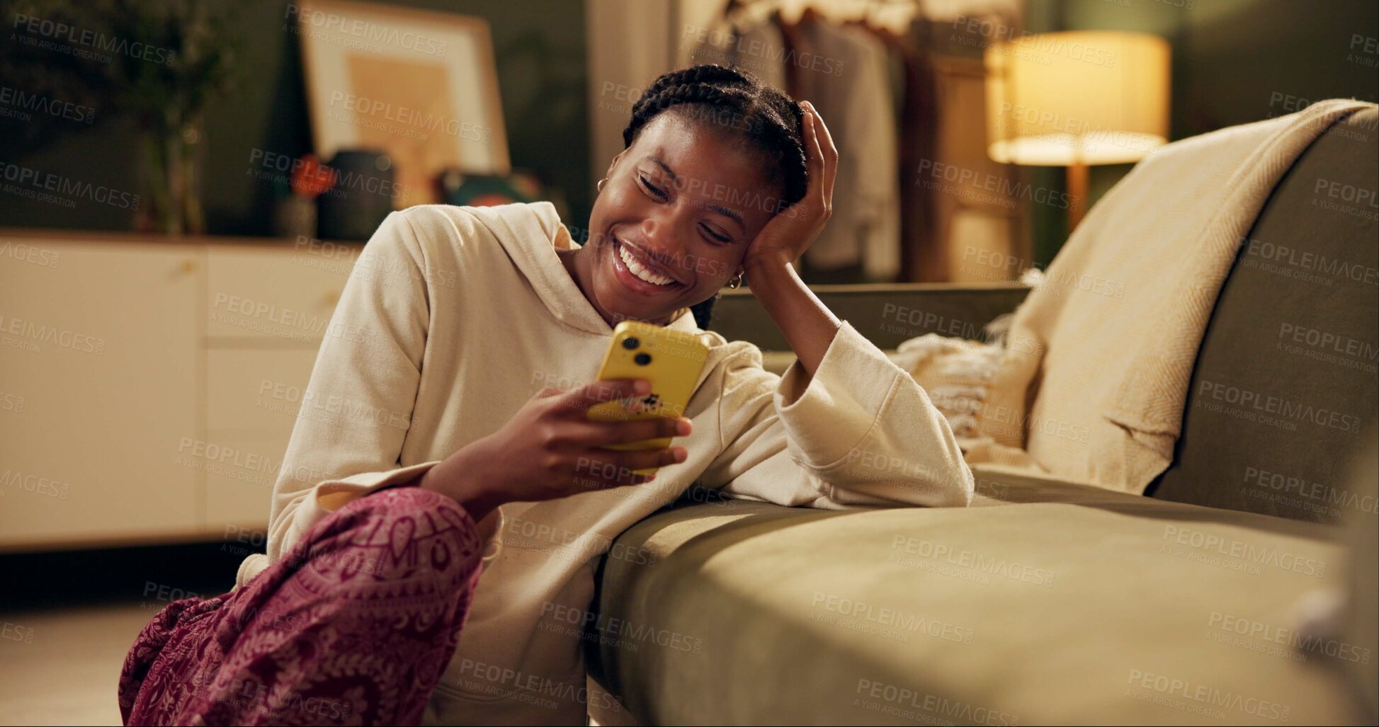 Buy stock photo Happy, laugh and black woman with phone on sofa for online chat, communication and networking. Relax, home and person on smartphone for social media, funny website and internet news in living room