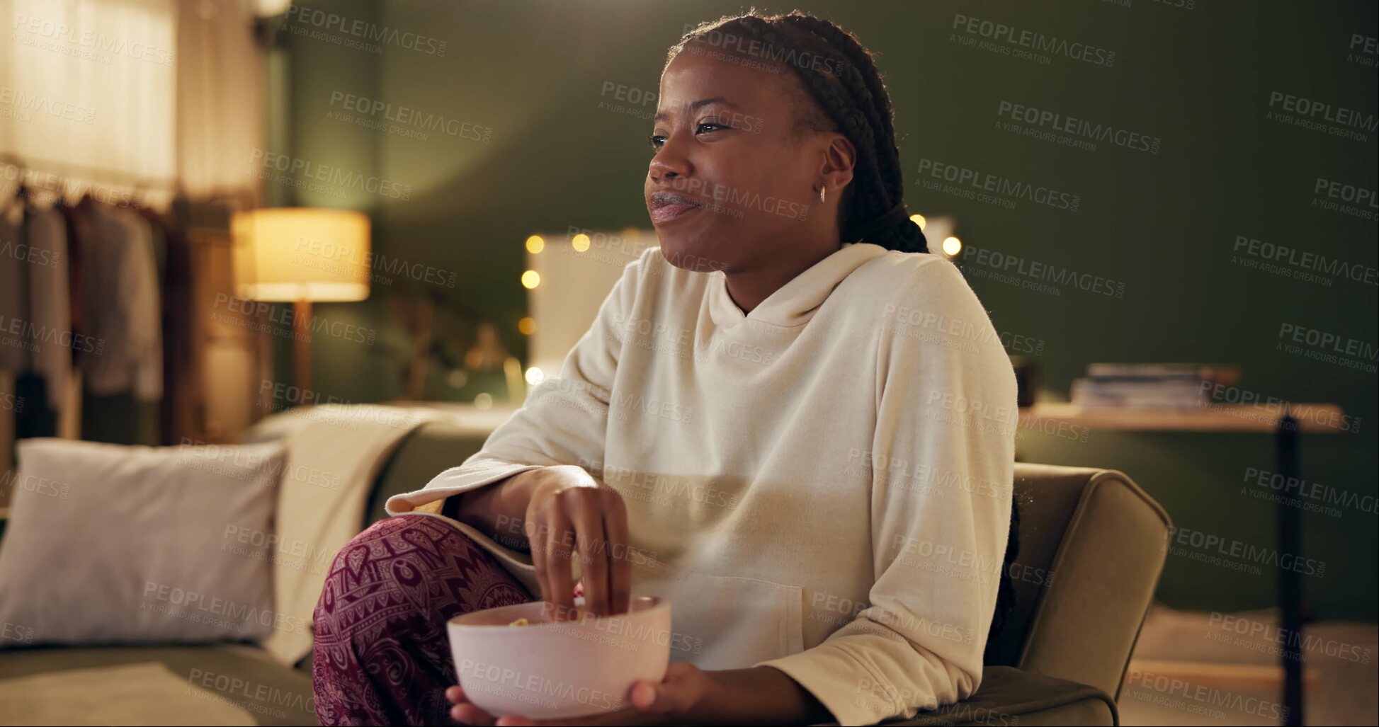 Buy stock photo Black girl, laugh and relax on couch with popcorn for movie night, streaming comedy shows or tv and entertainment. Woman, home and watching comic or funny video on sofa with snack for weekend leisure