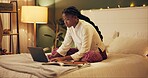 Education, laptop and night with black woman in bedroom at home for distance learning or remote study. Computer, notebook and research with college or university person on bed of apartment in evening