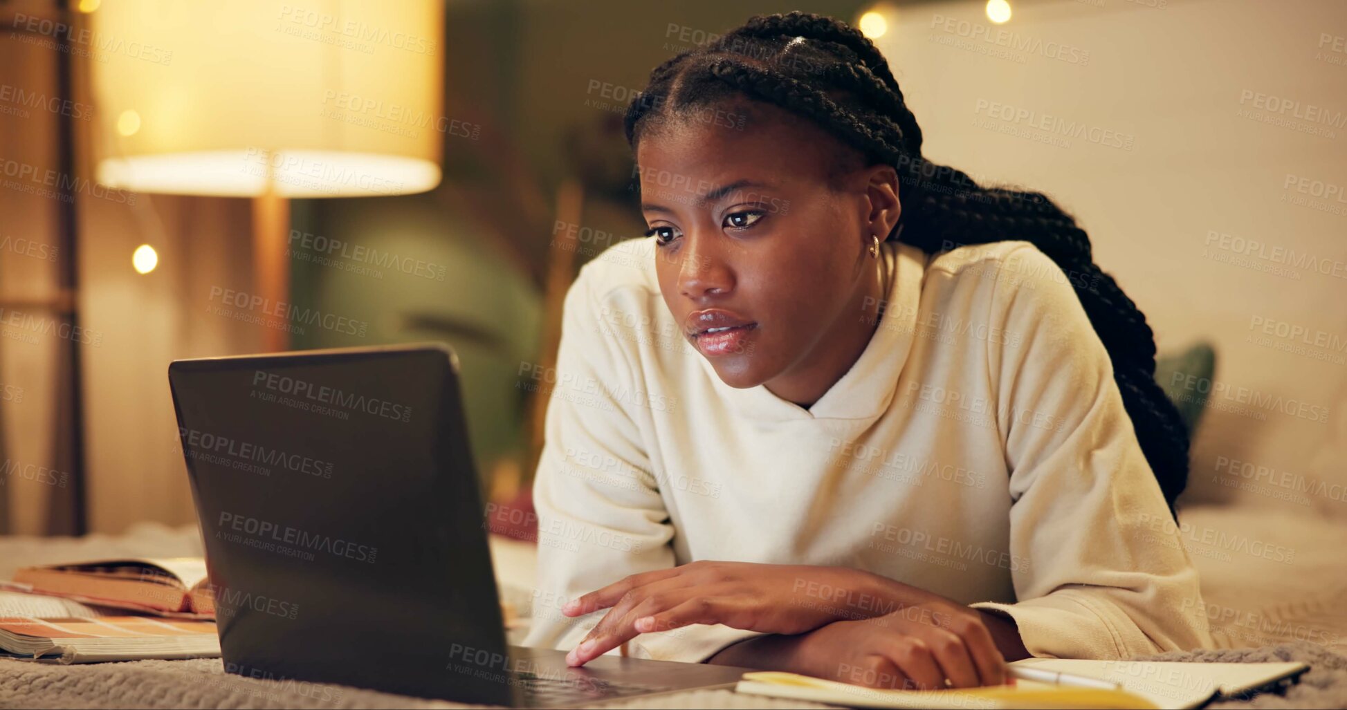 Buy stock photo Education, laptop and night with black woman on bed in home for distance learning or remote study. Computer, evening research and notebook with college or university person in bedroom of apartment