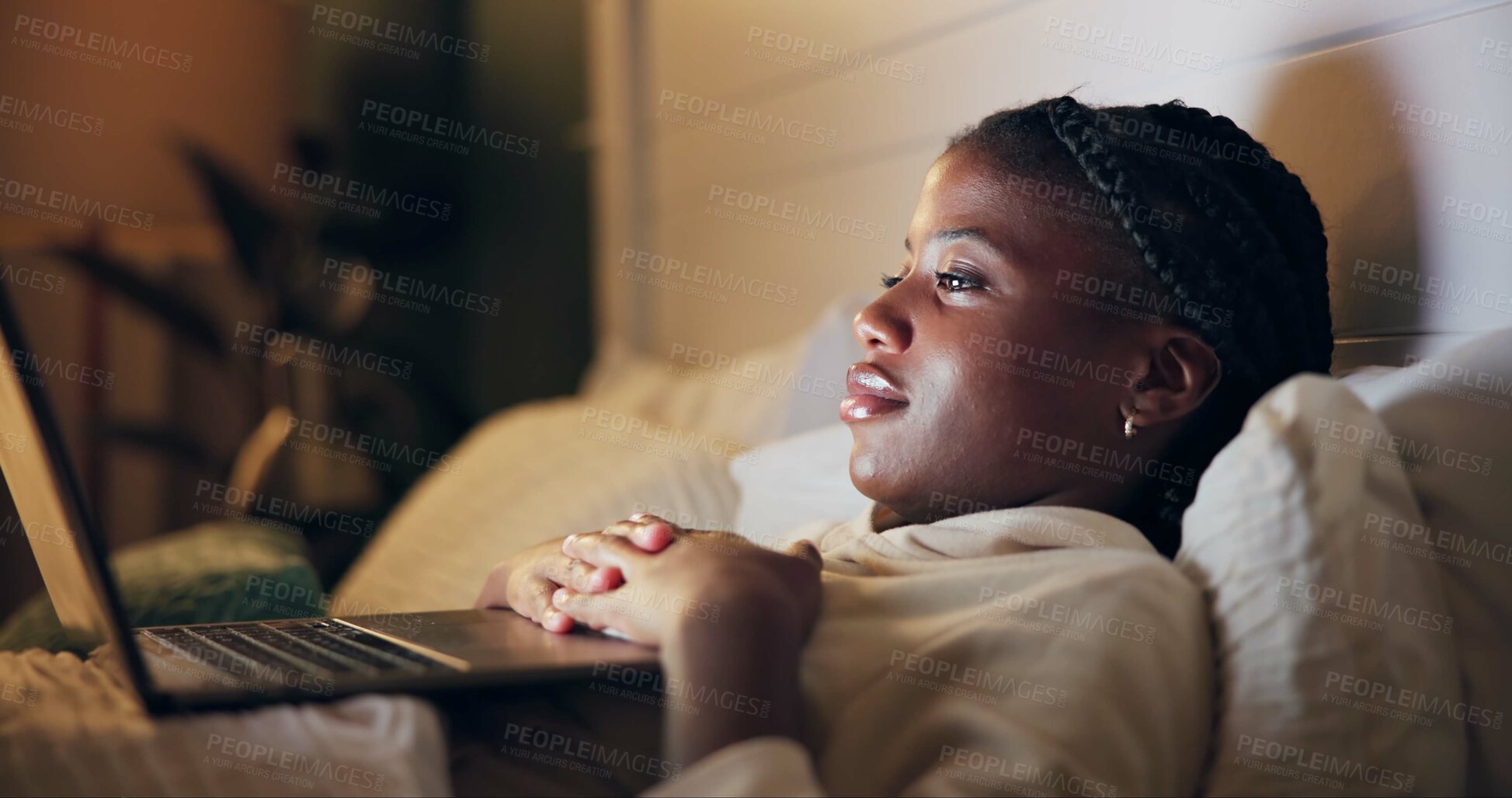 Buy stock photo Bed, watch and black woman on laptop for movie streaming service, film or comedy at night. Girl at home relax in bedroom with computer for online TV show, series and funny video on weekend or holiday