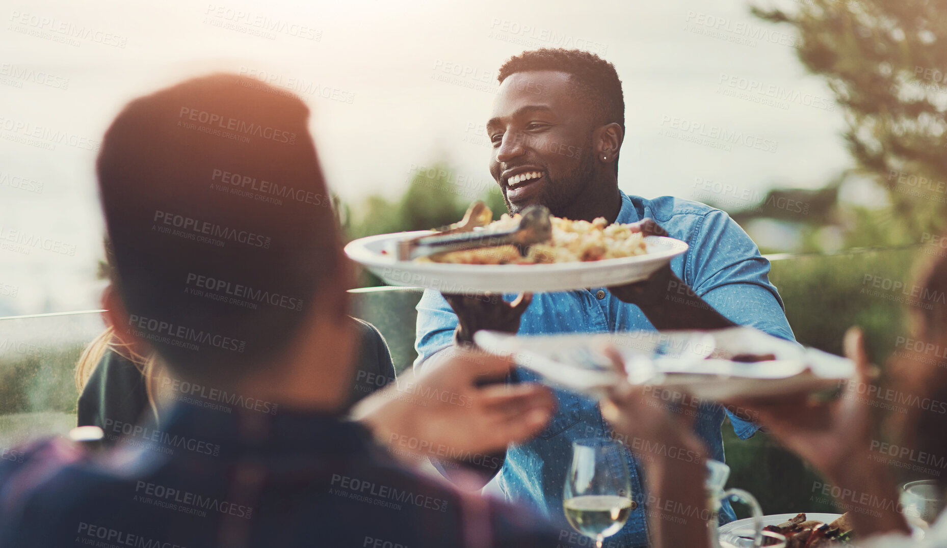 Buy stock photo Food, friends and man eating lunch at outdoor restaurant for Independence day event. Dinner, diversity and group of happy people with plate for meal, party or celebration together at social gathering