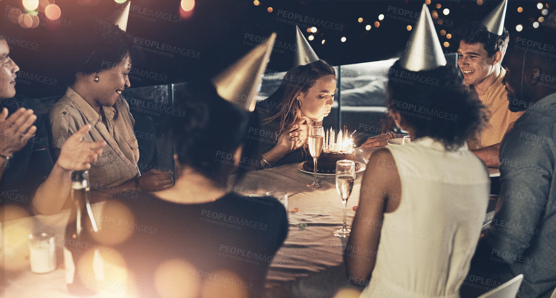 Buy stock photo Group of people, celebration and birthday cake as happy, cheerful and excited in crowd at table. Female person, blowing candles and party with applause, friends and gathering for event in restaurant