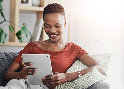 Buy stock photo Black woman, tablet and reading of post, sofa and happy with social media, online and smile for website. Digital, relax and streaming of movies, internet subscription and break on app and house