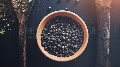 Buy stock photo Black pepper, kitchen and spices in top view on background for healthy, natural and organic food. Table, bowl and peppercorn above for seasoning herbs, condiments and cooking powder with ingredients