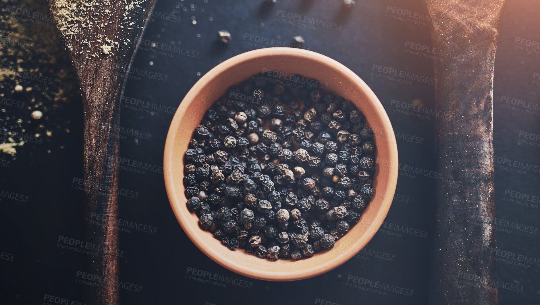 Buy stock photo Black pepper, kitchen and spices in top view on background for healthy, natural and organic food. Table, bowl and peppercorn above for seasoning herbs, condiments and cooking powder with ingredients