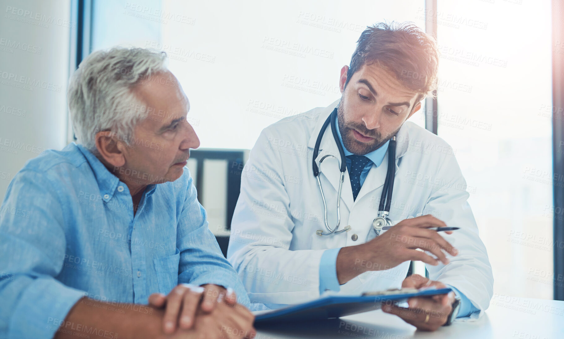 Buy stock photo Hospital, doctor and men with clipboard in discussion for health insurance, feedback or planning. People, patient and consultation with checklist at desk for coverage option, info or medical benefits