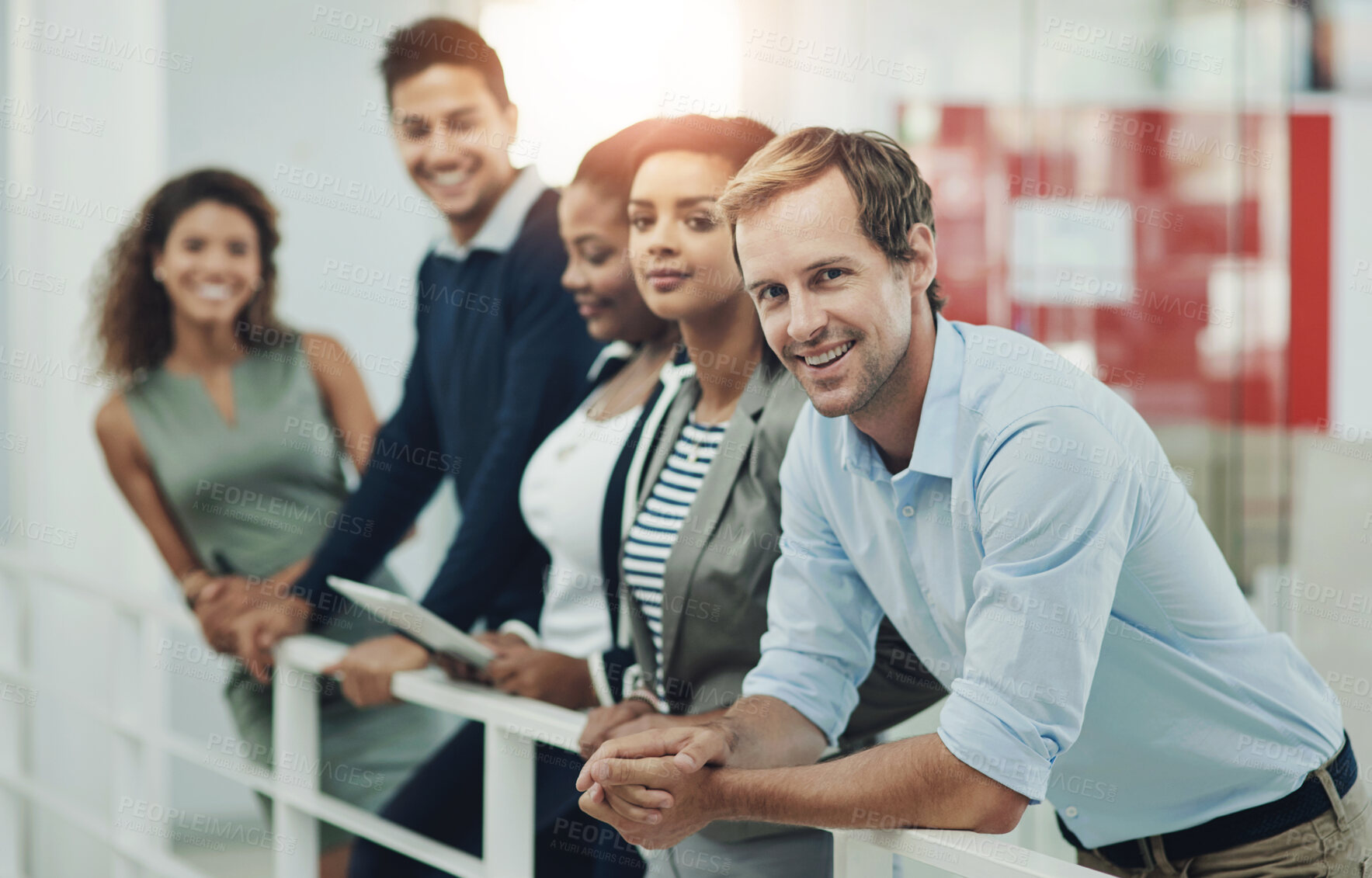 Buy stock photo Group, business and people standing by railing for communication, teamwork and ambition of startup. Smile, man and staff for creative, collaboration and diversity in lobby of company office together