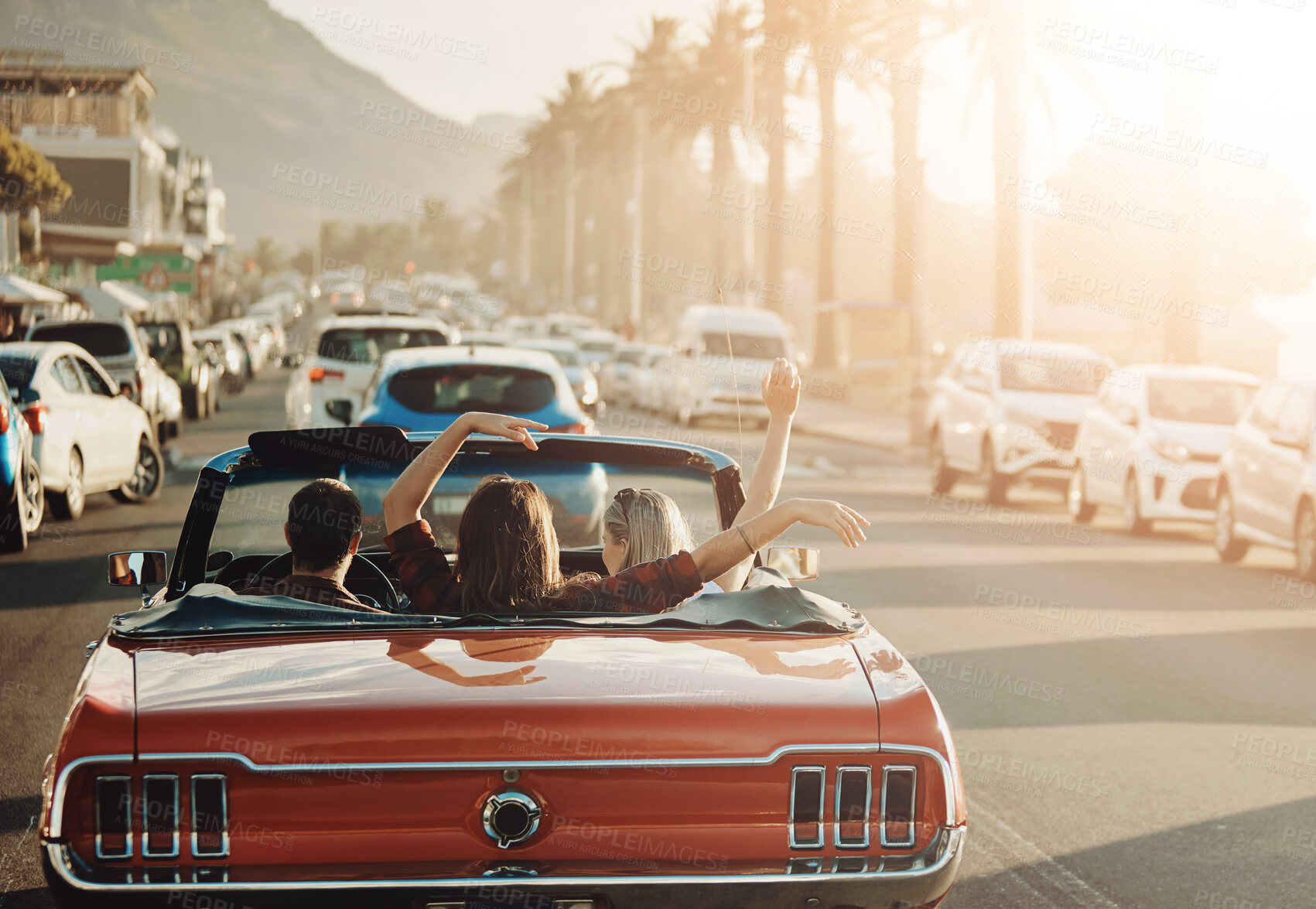 Buy stock photo Adventure, city and friends in car for road trip by sunset for vacation, holiday or journey. Freedom, travel and back of people in convertible vehicle for driving to weekend destination in California