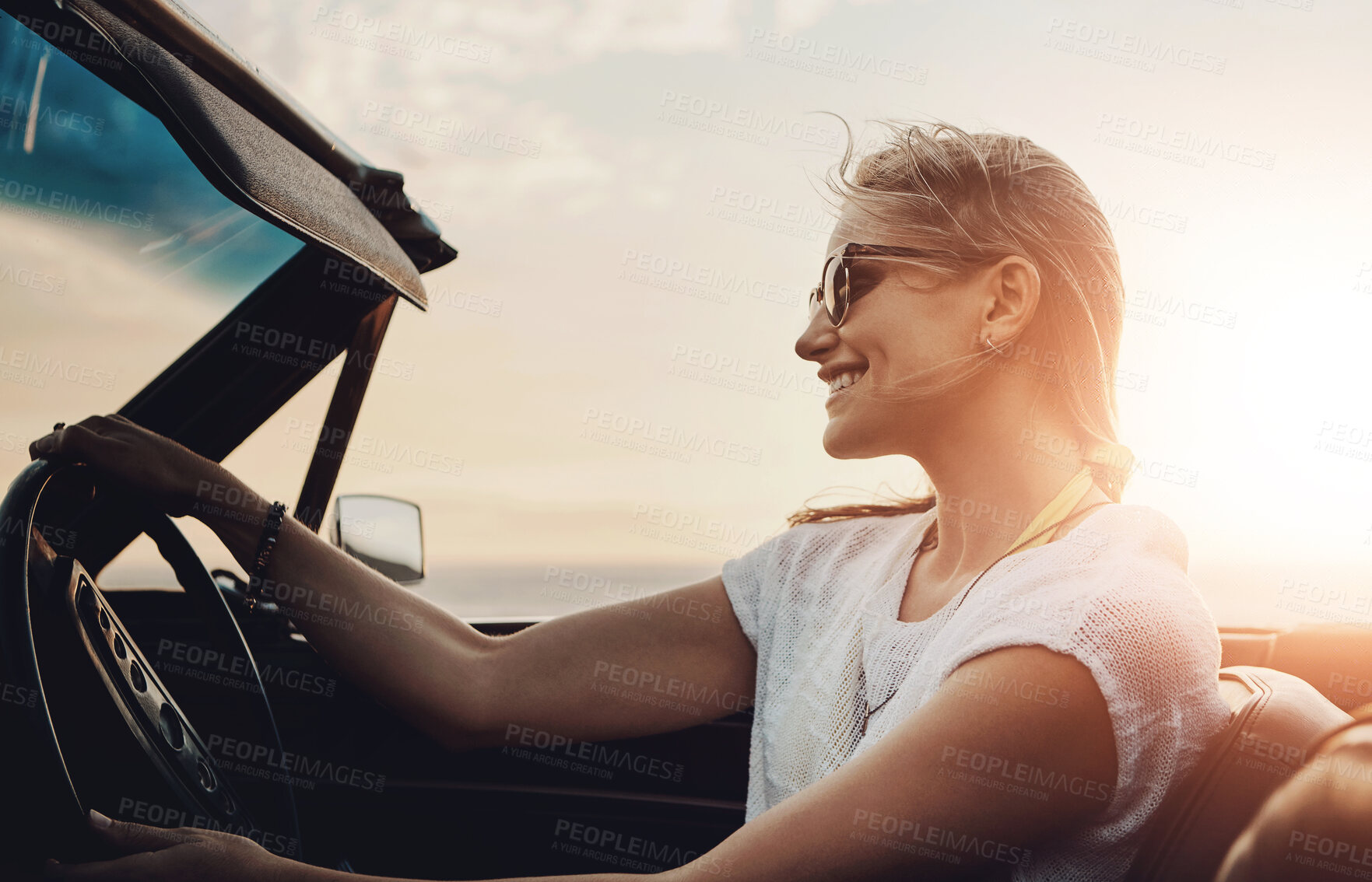 Buy stock photo Woman, driving and car in sunset for road trip, adventure and freedom with holiday or vacation. Excited and young driver with license, convertible and luxury vehicle for outdoor journey and travel