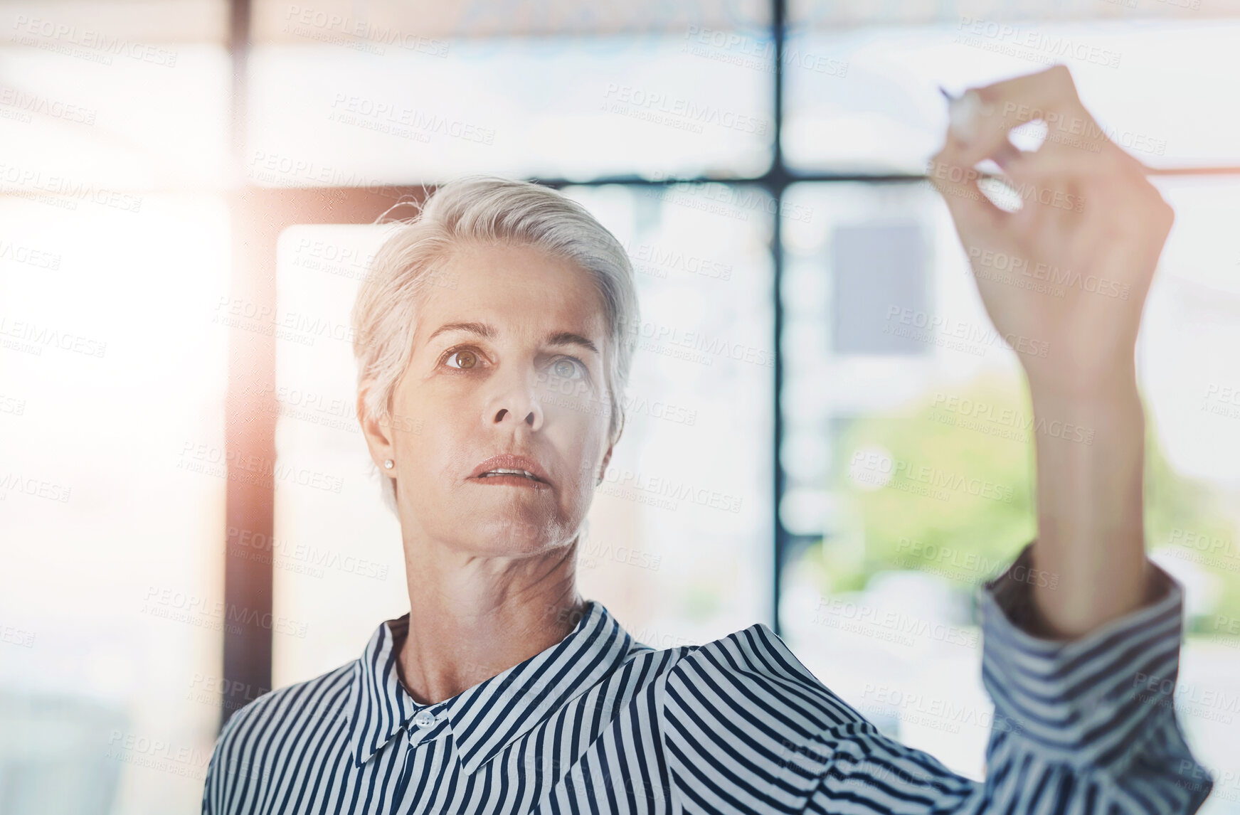 Buy stock photo Glass wall, writing and business woman in office for planning corporate investment strategy. Board, notes and mature female financial analyst brainstorming for stock market shares for company profit.