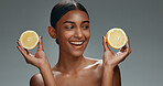 Beauty, skincare and happy woman in studio with lemon, natural cosmetics isolated on grey background. Makeup, organic vitamin c dermatology and skin care model with spa or salon fruit detox facial.