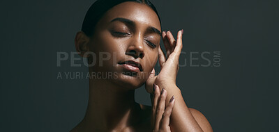 Beauty, sensual and face of woman in a studio with body care, wellness and health routine. Cosmetic, movement and portrait of an Indian female model with glowing skin treatment by a black background.
