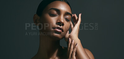 Buy stock photo Beauty, sensual and face of woman in a studio with body care, wellness and health routine. Cosmetic, movement and portrait of an Indian female model with glowing skin treatment by a black background.