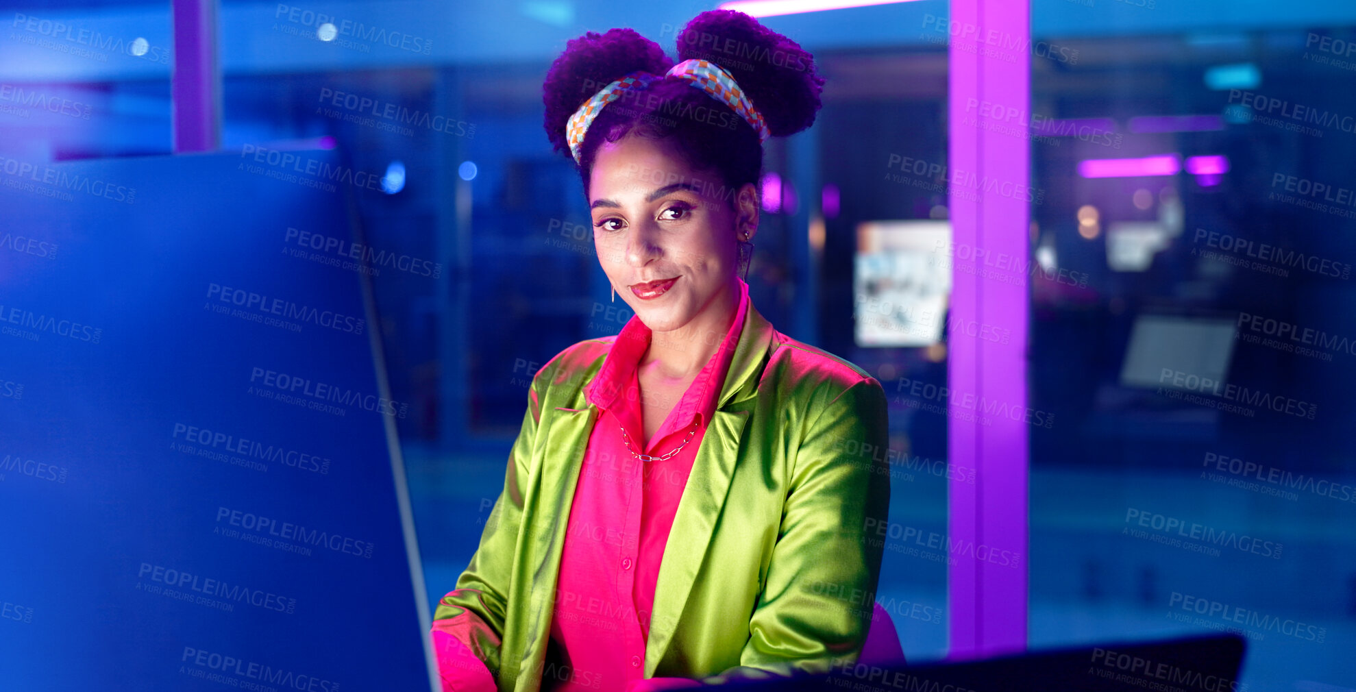 Buy stock photo Face, computer and neon with programmer woman in office at night for coding or developing. Portrait, smile or happy young game developer sitting at desk in workplace with virtual system update