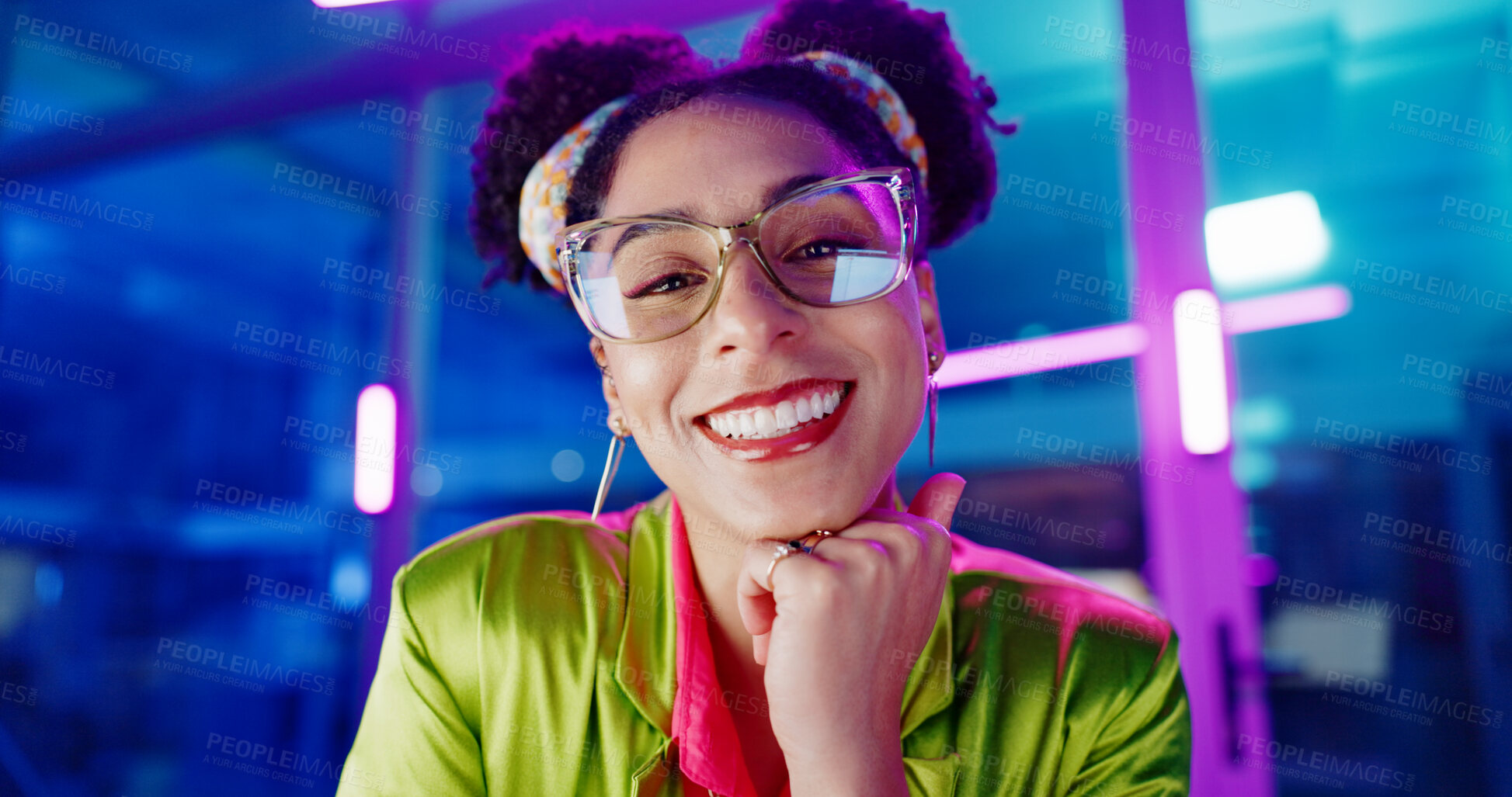 Buy stock photo Face, computer and neon with programmer woman in office at night for coding or developing. Portrait, smile or happy young game developer sitting at desk in workplace with virtual system update