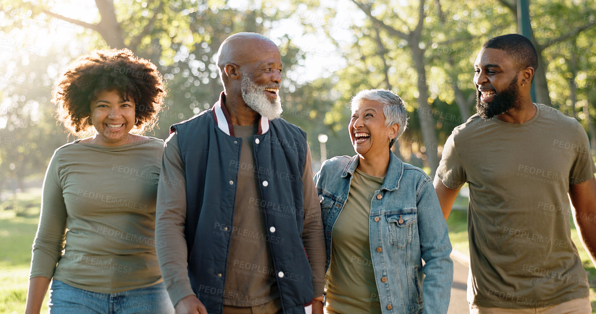 Buy stock photo Walking, outdoor and family in park, sunshine and happiness with weekend break, hobby and activity. Group, parents and kids with mother, father and conversation with smile, bonding together and joy