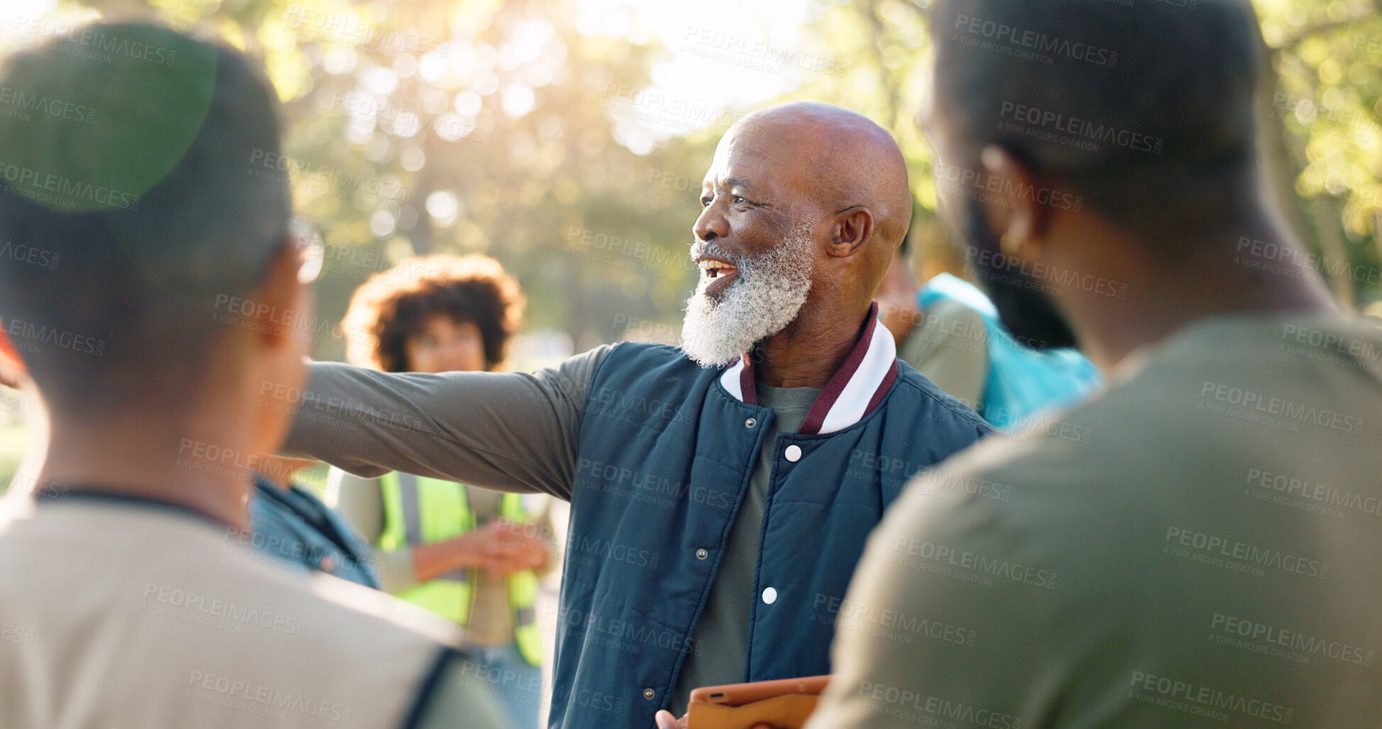 Buy stock photo Park, black man and volunteers discussion with tablet for support, community project or nature sustainability. Humanitarian, recycling or senior leader in charity service or NGO for pollution cleanup