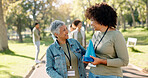 Happy, woman and volunteer talking in outdoors of traffic cones for activity management, safety protocol or crowd control. Smile, people and park assistance for charity responsibility of coordination