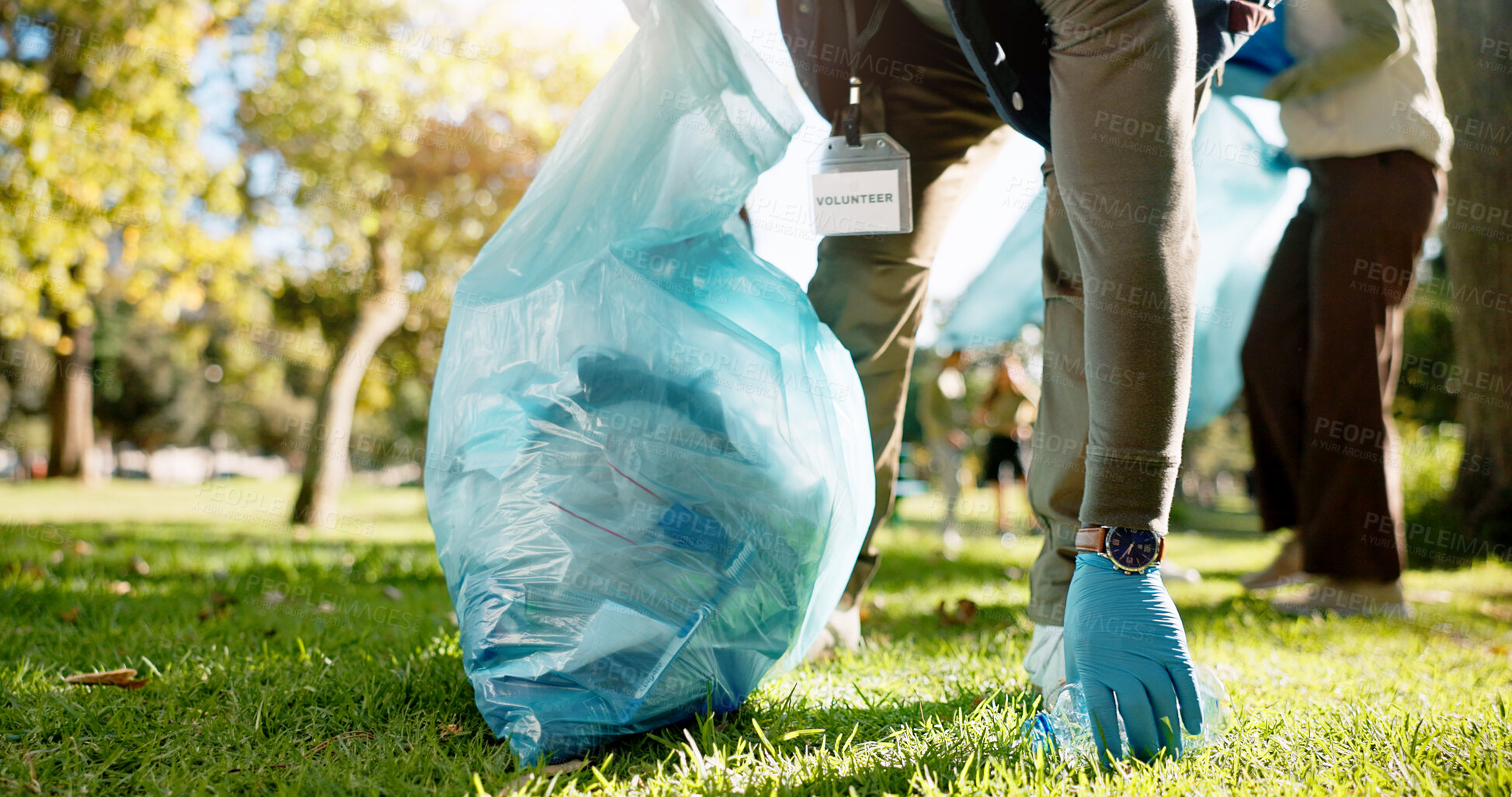 Buy stock photo Hand, person and charity with pick up dirt at park with plastic for cleaning, care and community service. Grass, littering and waste or pollution for maintenance, environment and health as volunteer