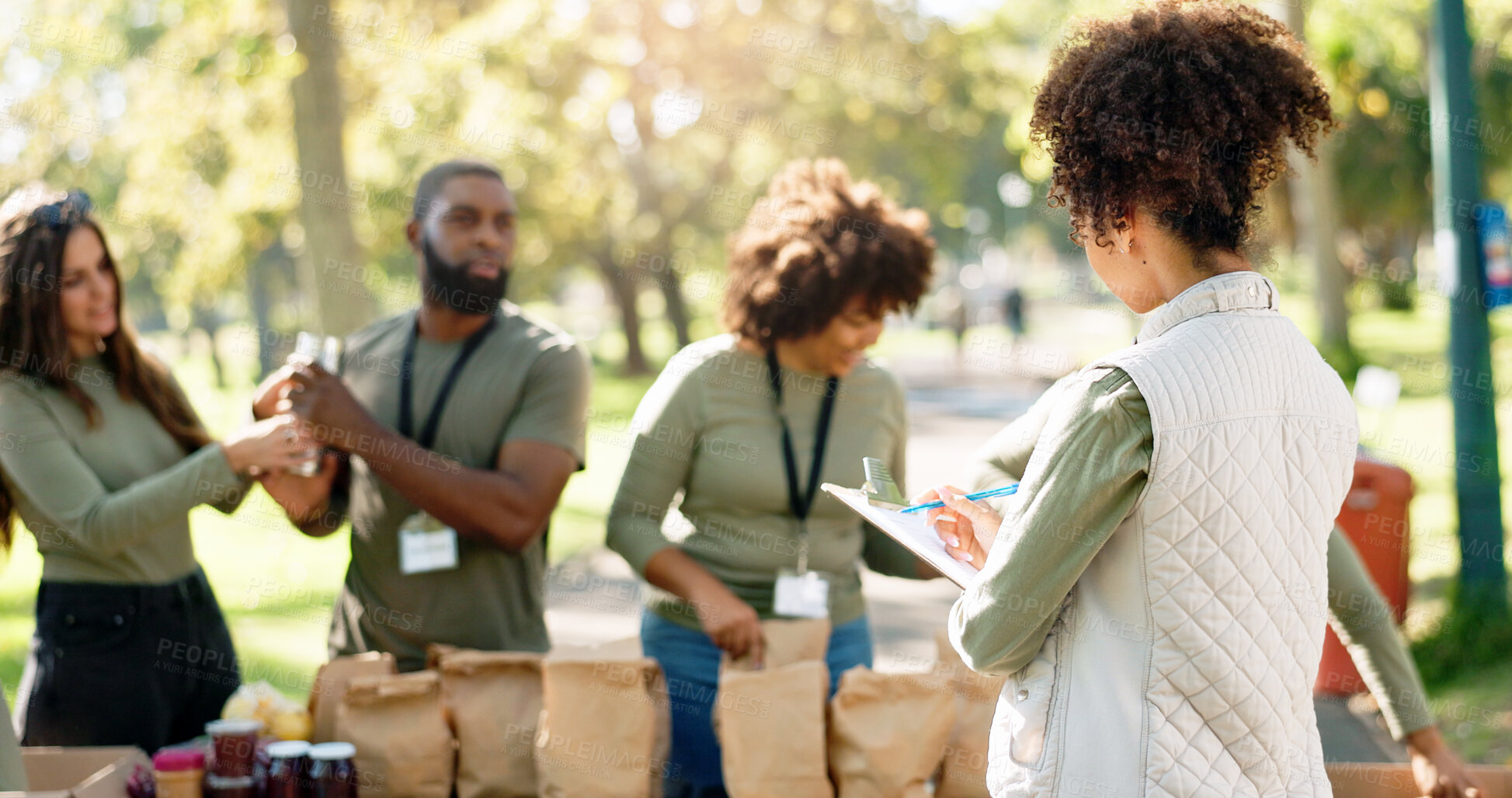 Buy stock photo Woman, clipboard and volunteering group or helping, kindness ngo and charity project with community in park. Distribution, food parcel and grocery boxes for donation, teamwork and care with checklist