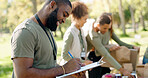 Happy people, volunteer and writing with clipboard for checklist on food, stock or supplies in charity at outdoor park. Man and team working together for NGO, mission or community service in nature