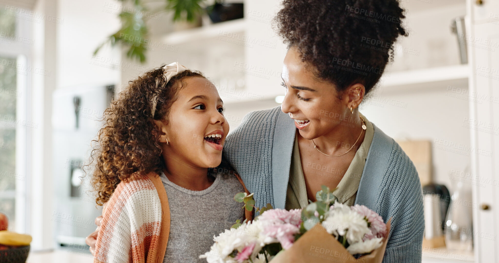 Buy stock photo Kitchen, mother and girl with surprise, flowers and present for birthday, love and family in house. Home, mom and daughter with embrace, happiness and cute in apartment, woman and child with smile