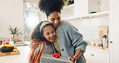 Buy stock photo Kitchen, mother and girl with gift, hug and smile for mothers day, love and care in family and house. Home, mom and daughter with embrace, happiness and cute in apartment, woman or child with present